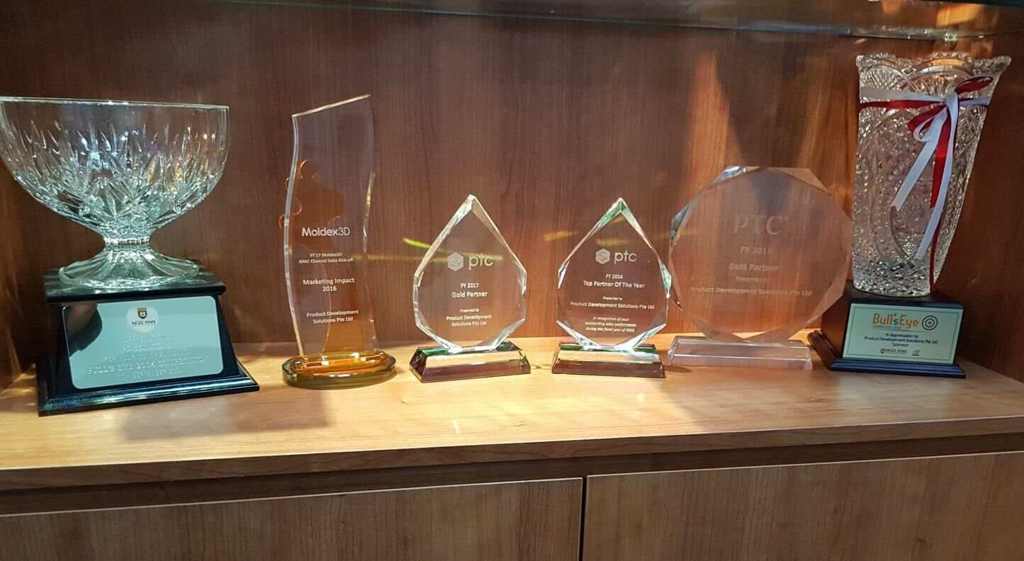 a shelf of awards won by pd solutions